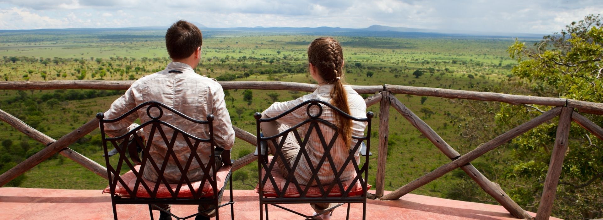 Couple enjoying the view from a safari lodge balcony
